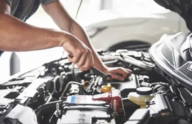 muscular-car-service-worker-repairing-vehicle-344w