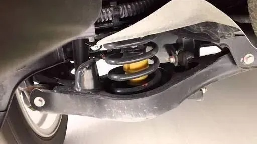 a close up of the rear suspension of a car .