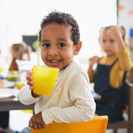 Little kid holding a cup — Richfield, NC — Richfield Child Development Center Little kid holding a cup — Richfield, NC — Richfield Child Development Center