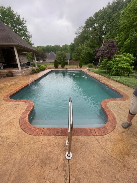 A large swimming pool with a staircase leading to it