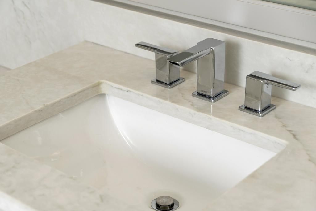 Modern bathroom sink with chrome faucet and white countertop sink basin