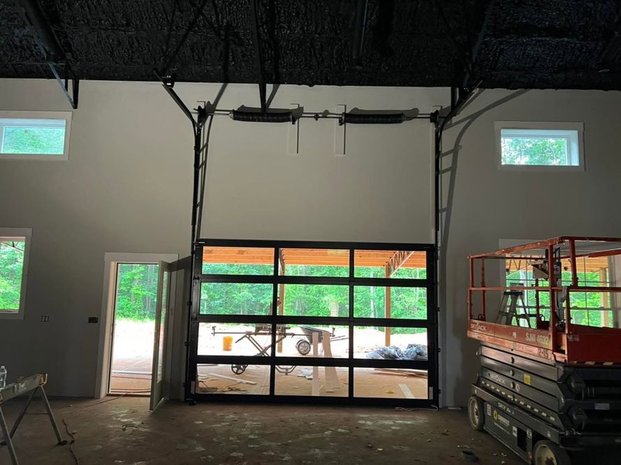 Empty warehouse interior with an open loading bay and stacked carts on the right