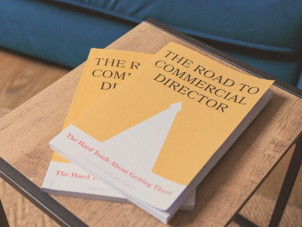 Two copies of The Road to Commercial Director on a wooden side table