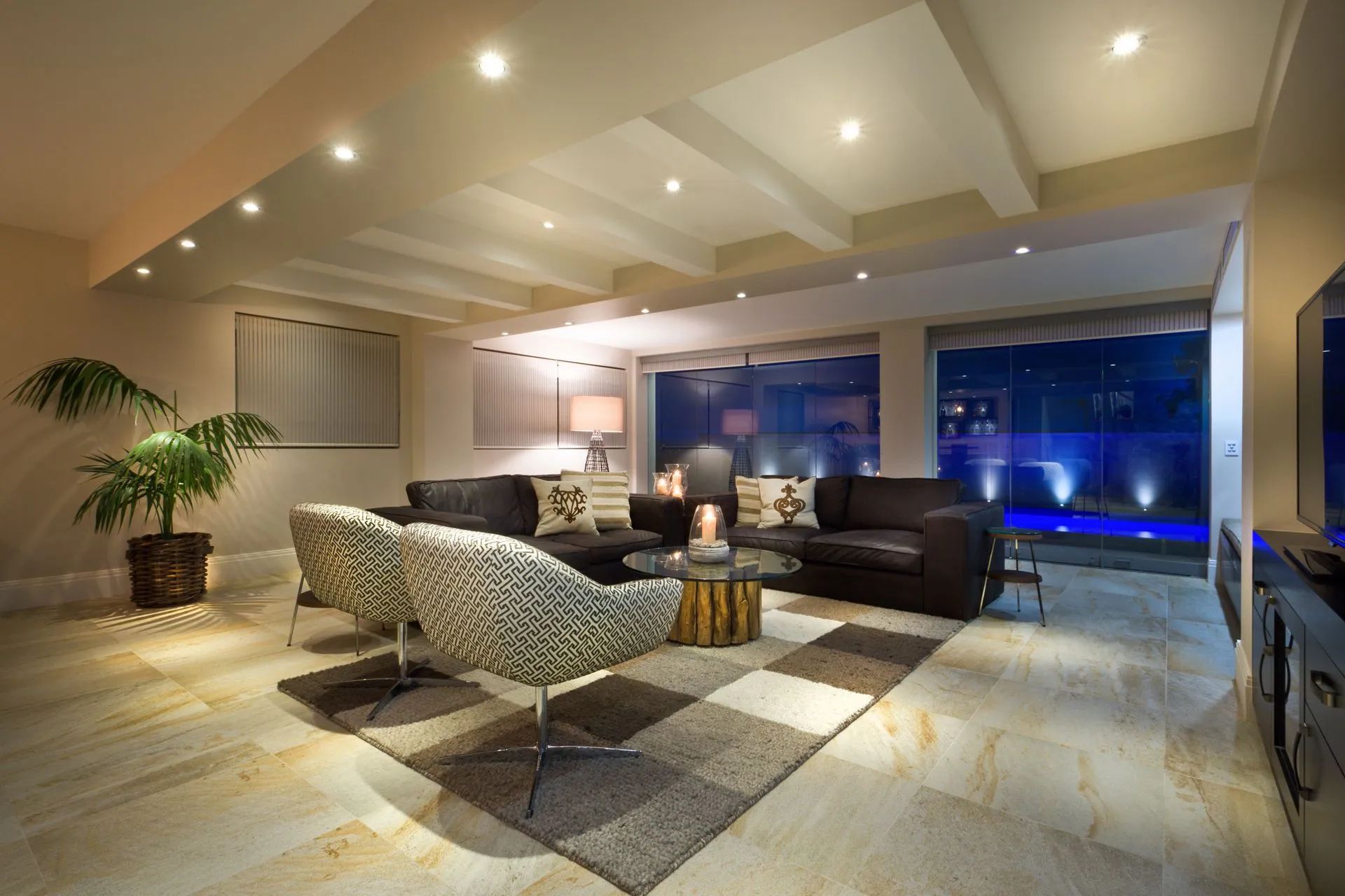 A living room with a couch , chairs , a table and a television.