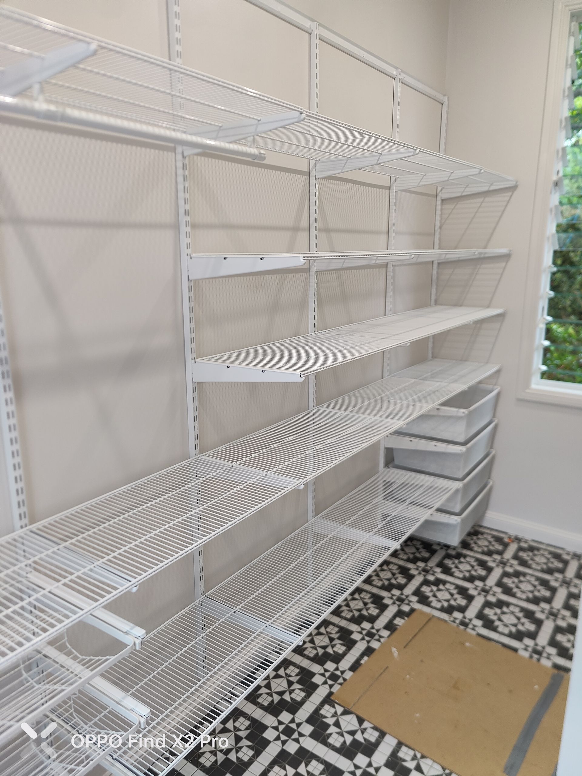 A wardrobe with white racks and a tiles floor — Cairns Custom Wardrobes in Manunda, QLD