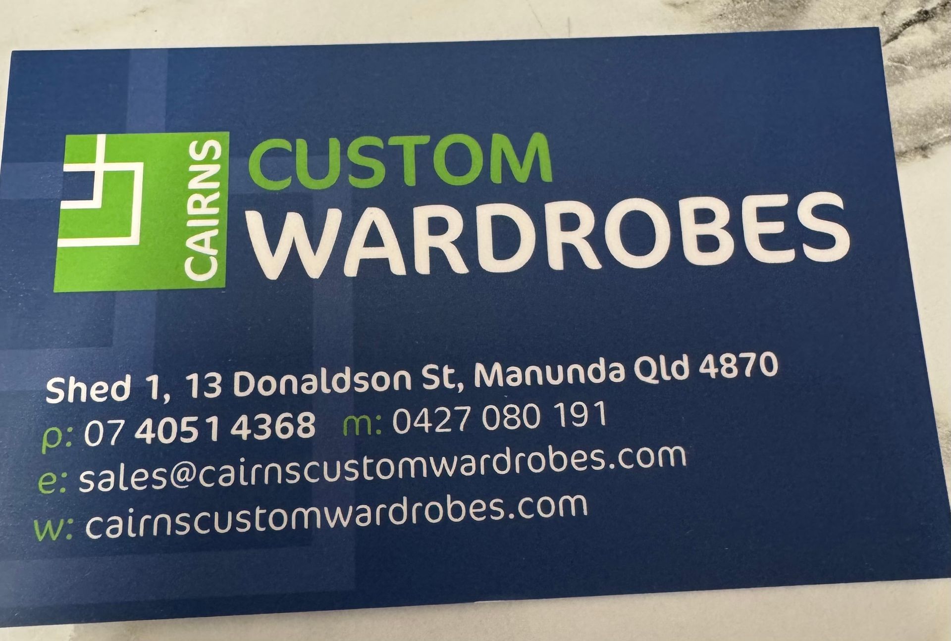 A business card with the business details — Cairns Custom Wardrobes in Manunda, QLD