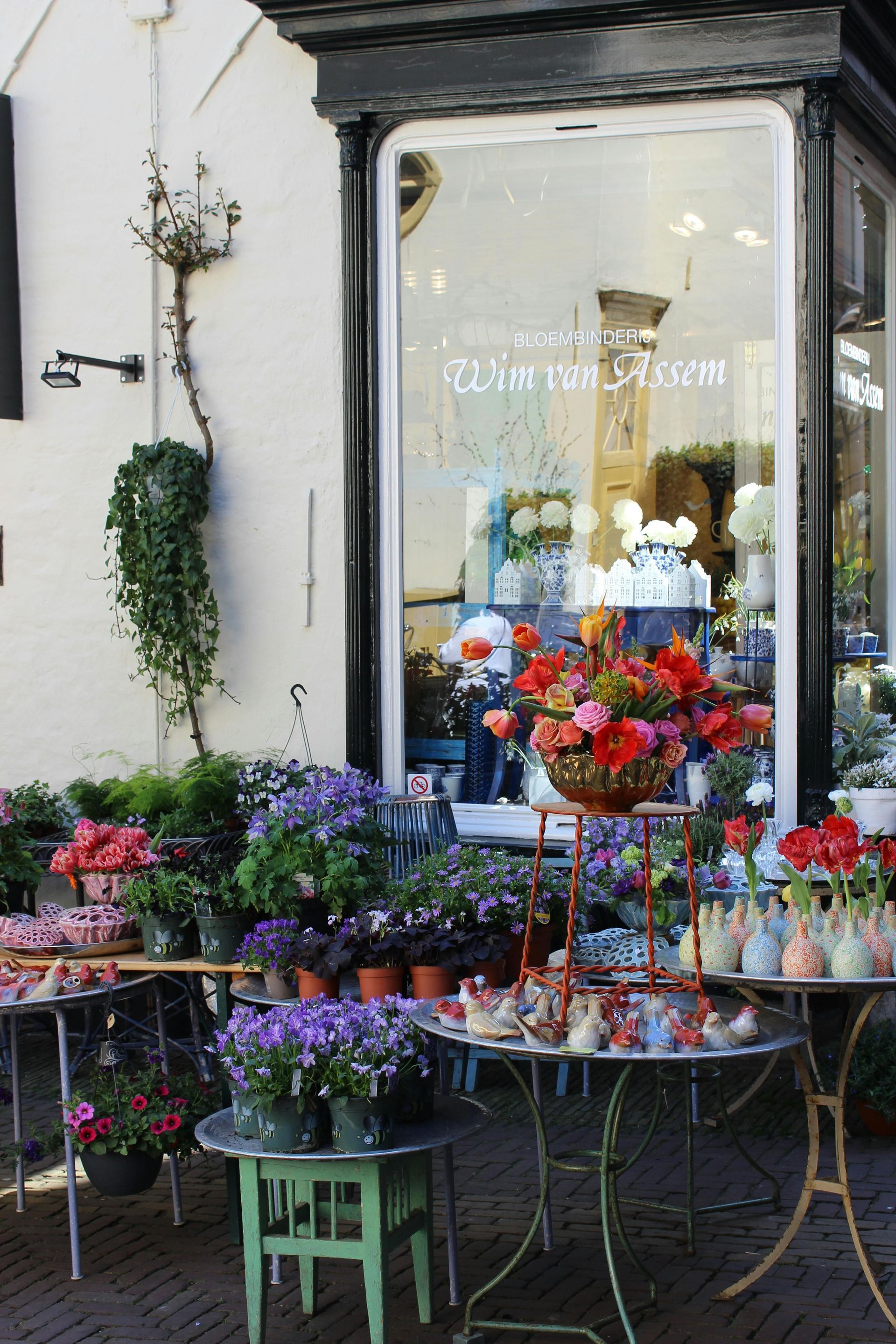 A display of flowers outside of a flower shop