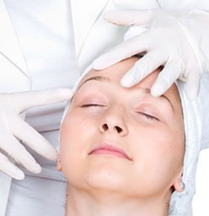 A woman is getting a facial treatment from a doctor.