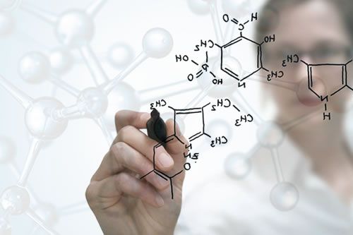 A person is writing a cosmetic formula on a white board