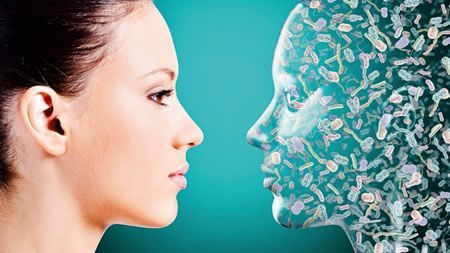 A woman is looking at a computer generated image of her face.