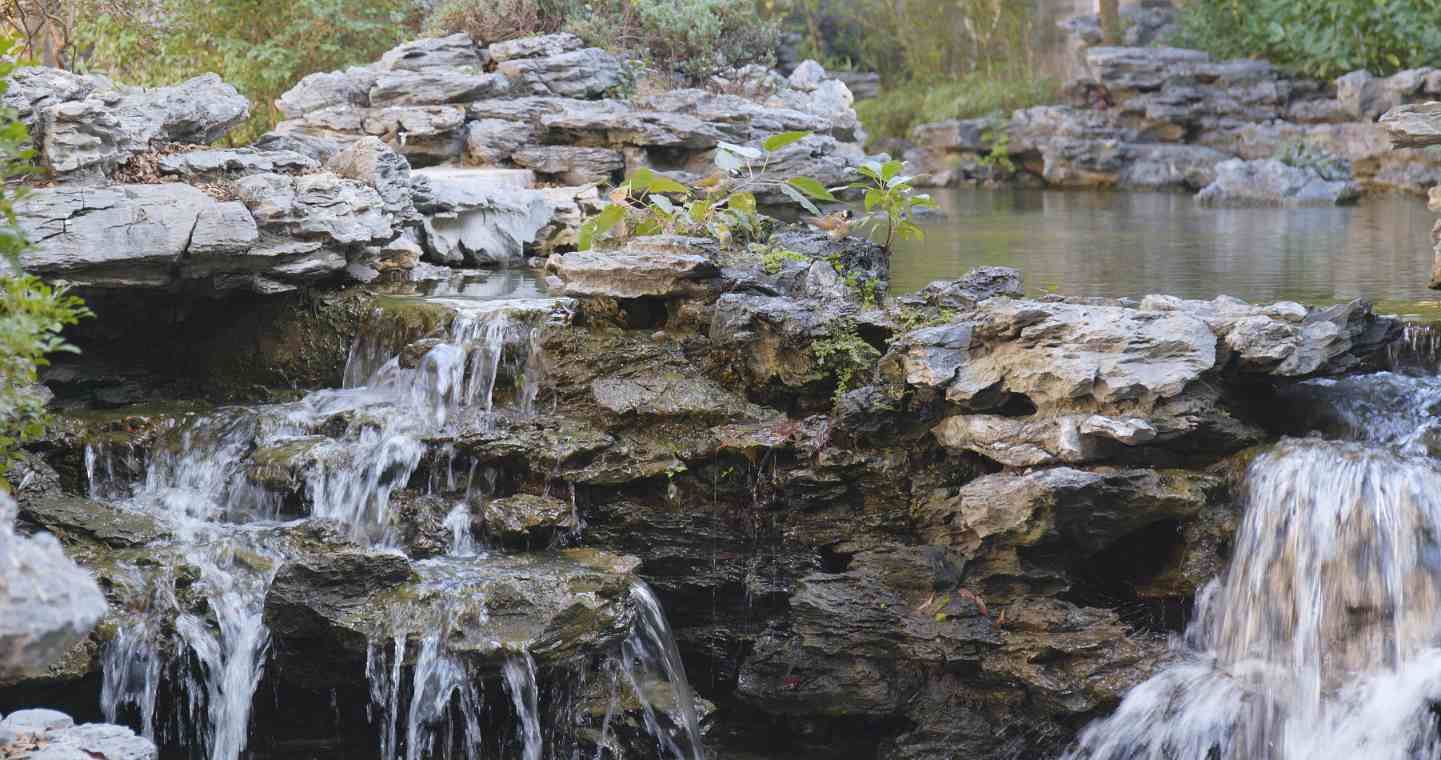 A pondless waterfall installation in North Tampa provides the beauty of cascading water without a traditional pond.