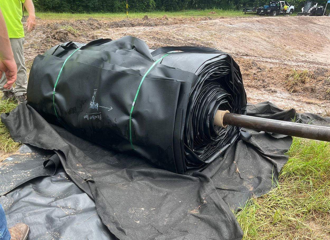 rolled RPE liner while team prepares for install