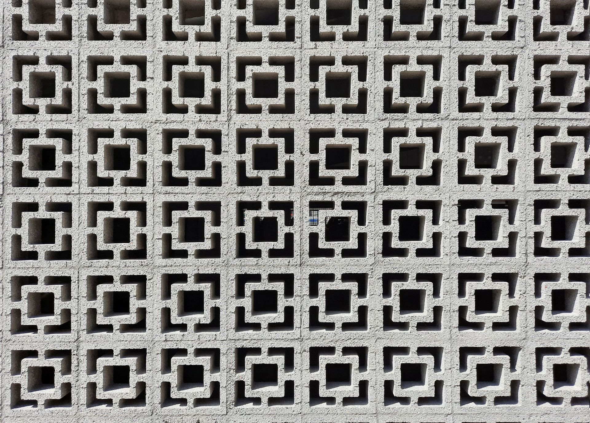 Black-and-white geometric tile pattern with repeating square motifs