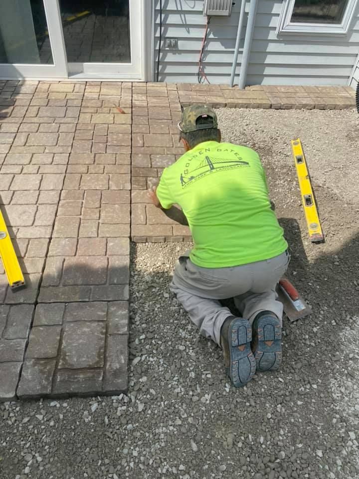 golden gates landscaper laying natural stone tile for a patio