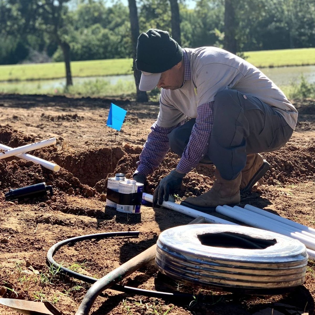 man installing sprinkler system