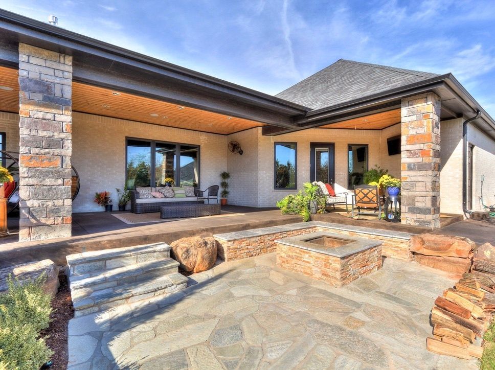 natural stone patio with firepit in backyard