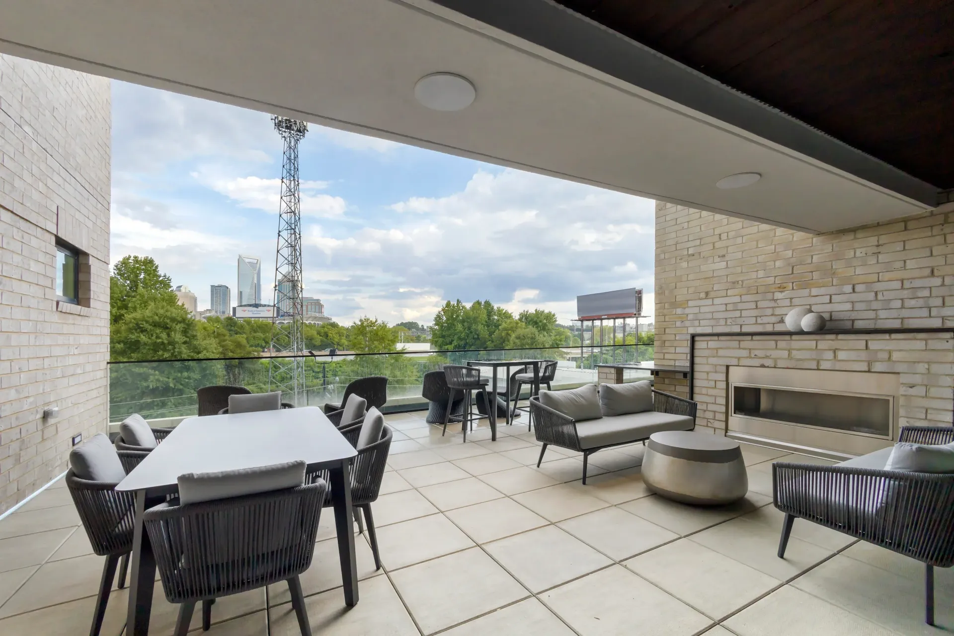 Rooftop terrace with outdoor seating, a fireplace, and a city skyline view.
