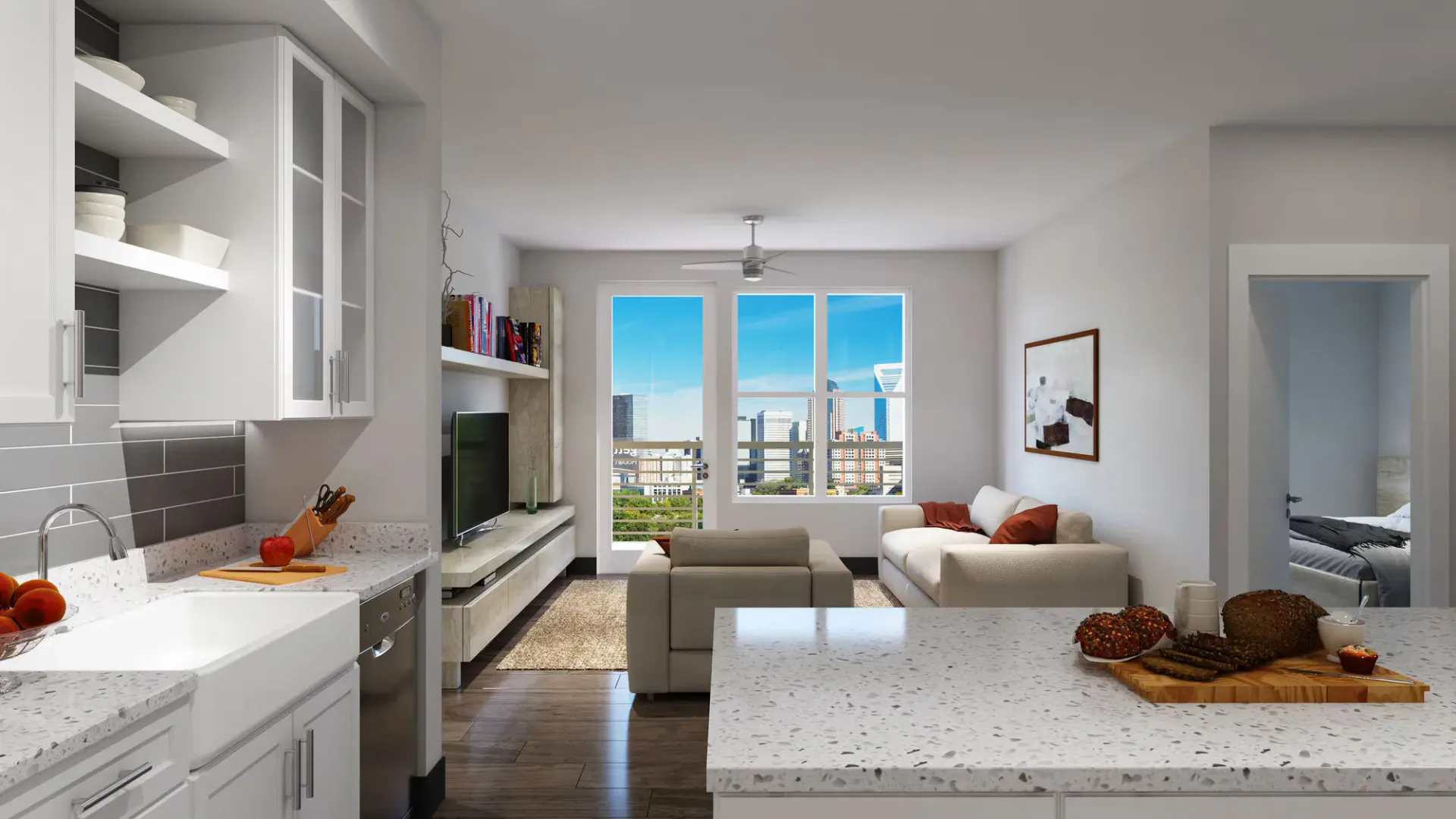 Open-concept kitchen and living area in a modern apartment with large windows and city views.