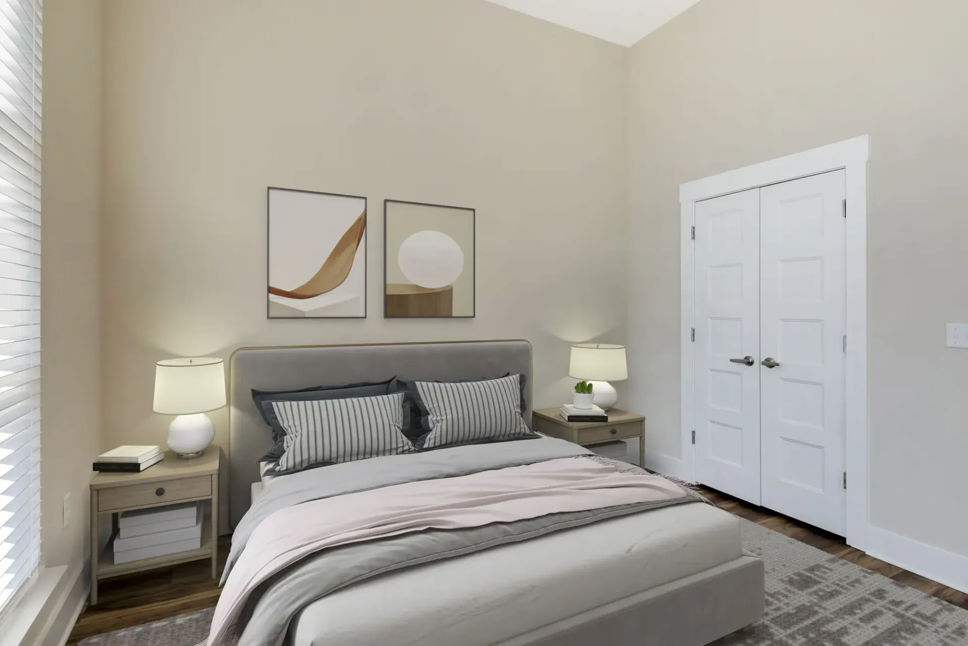 Bedroom scene with padded headboard, two nightstands, lamps, framed art, and a white door.