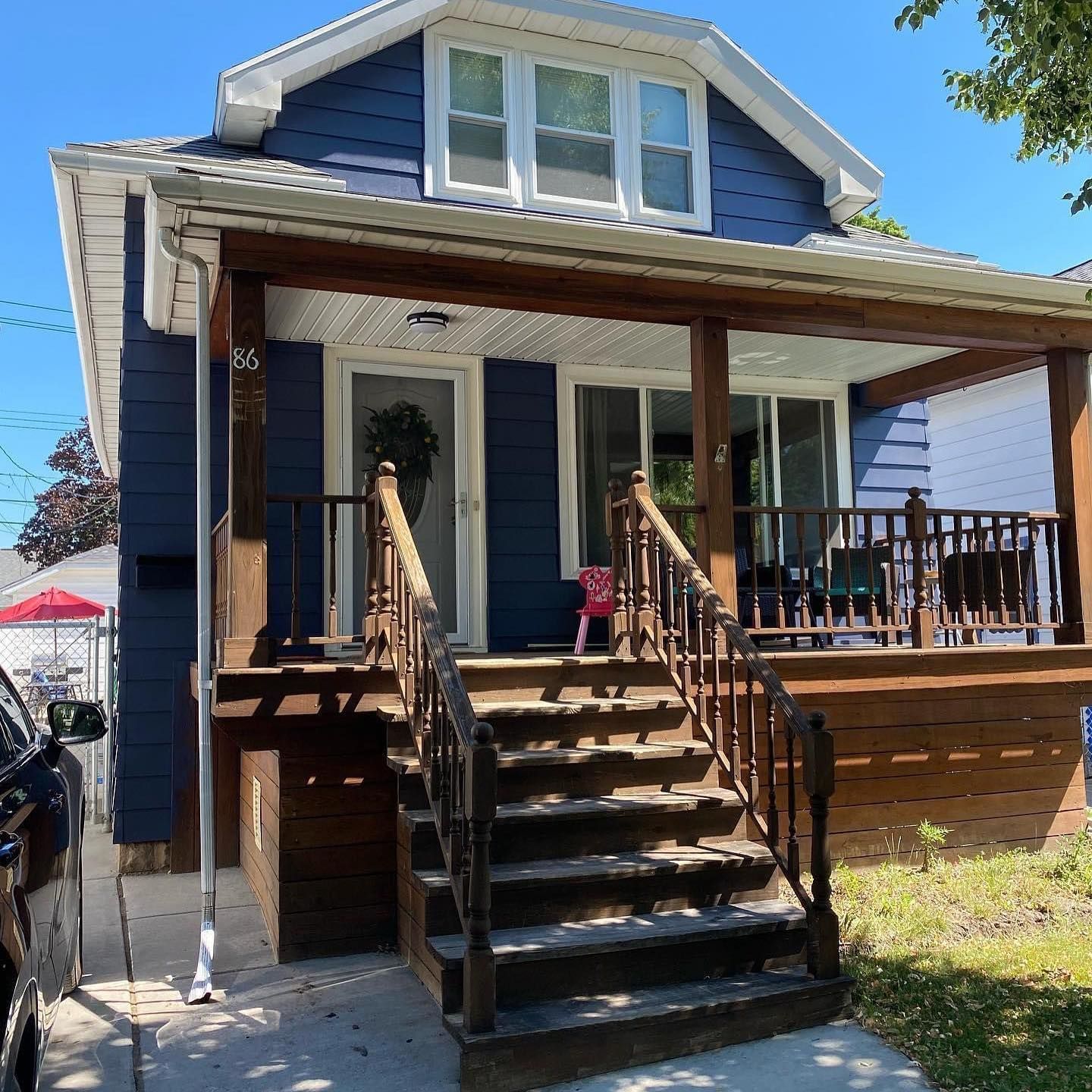 A blue house with a porch and stairs