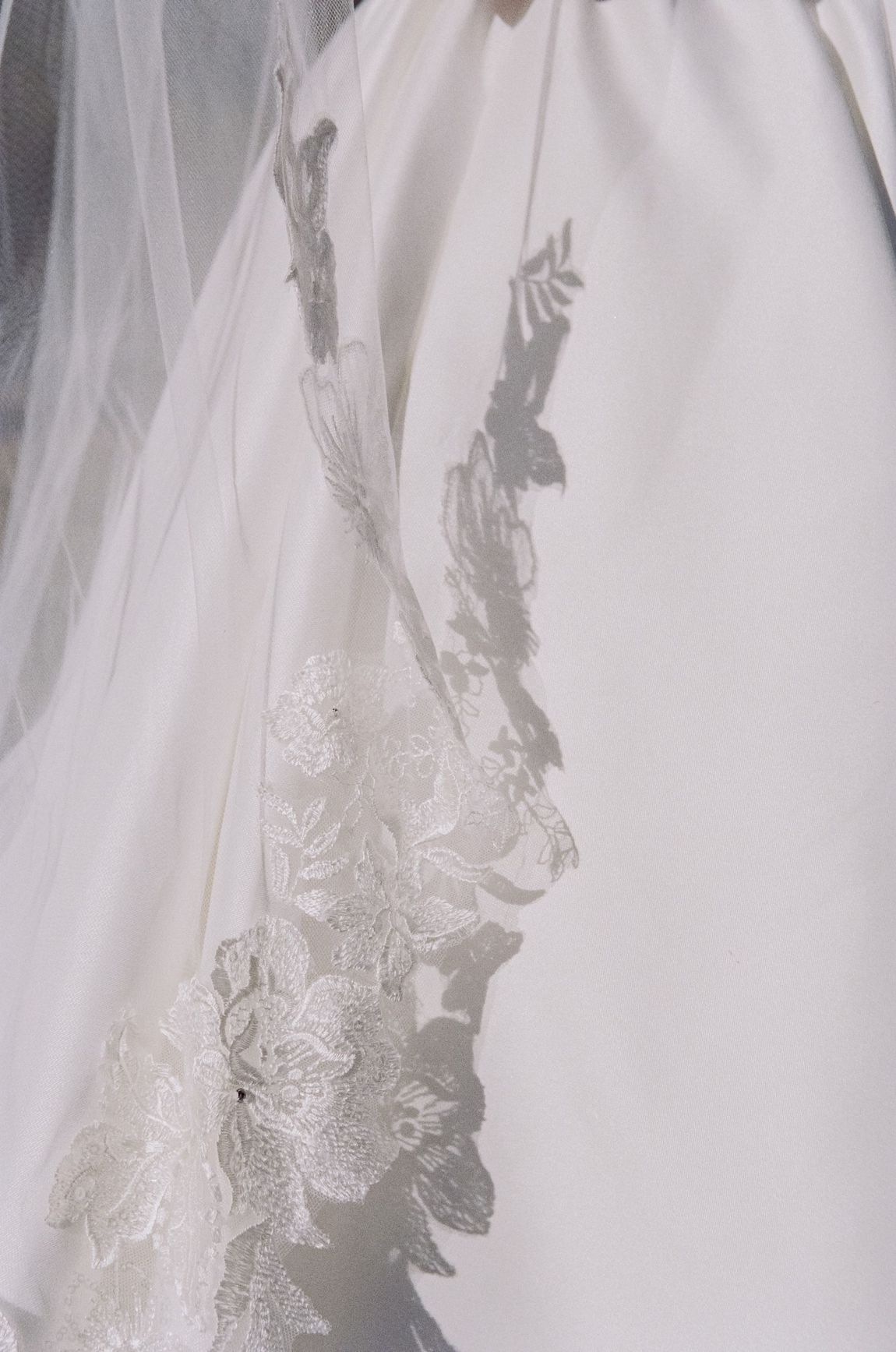 A close up of a bride 's wedding dress with a veil at a luxury wedding in Newport RI.