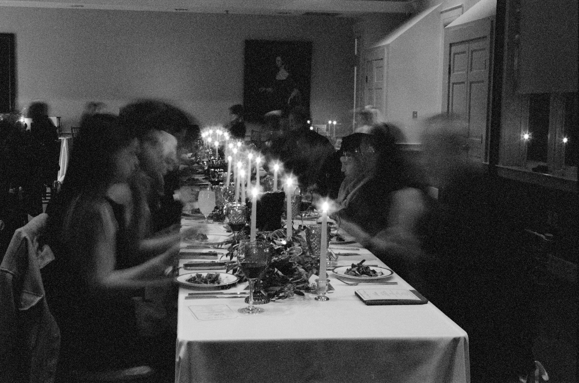 A group of people are sitting at a long table at a luxury wedding.