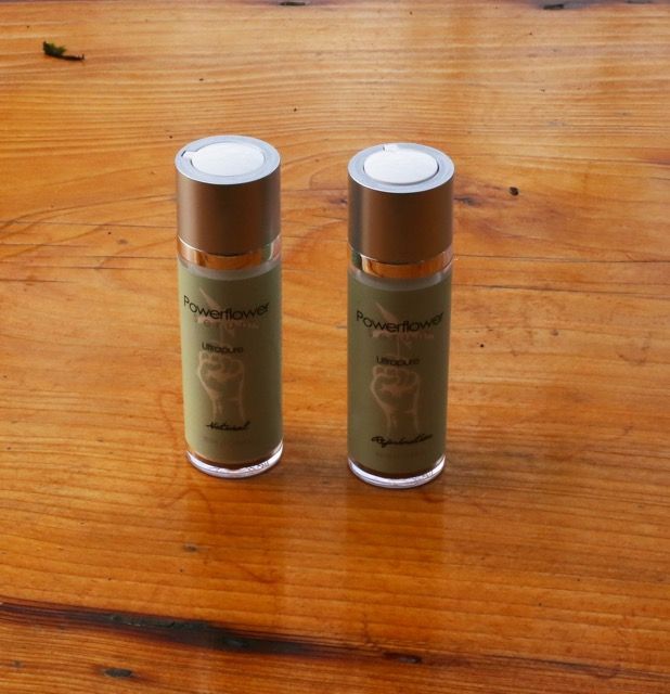 Two small silver-capped bottles standing on a wooden table