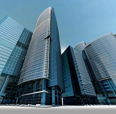 Modern glass office skyscrapers with curved facades against a blue sky Modern glass office skyscrapers with curved facades against a blue sky
