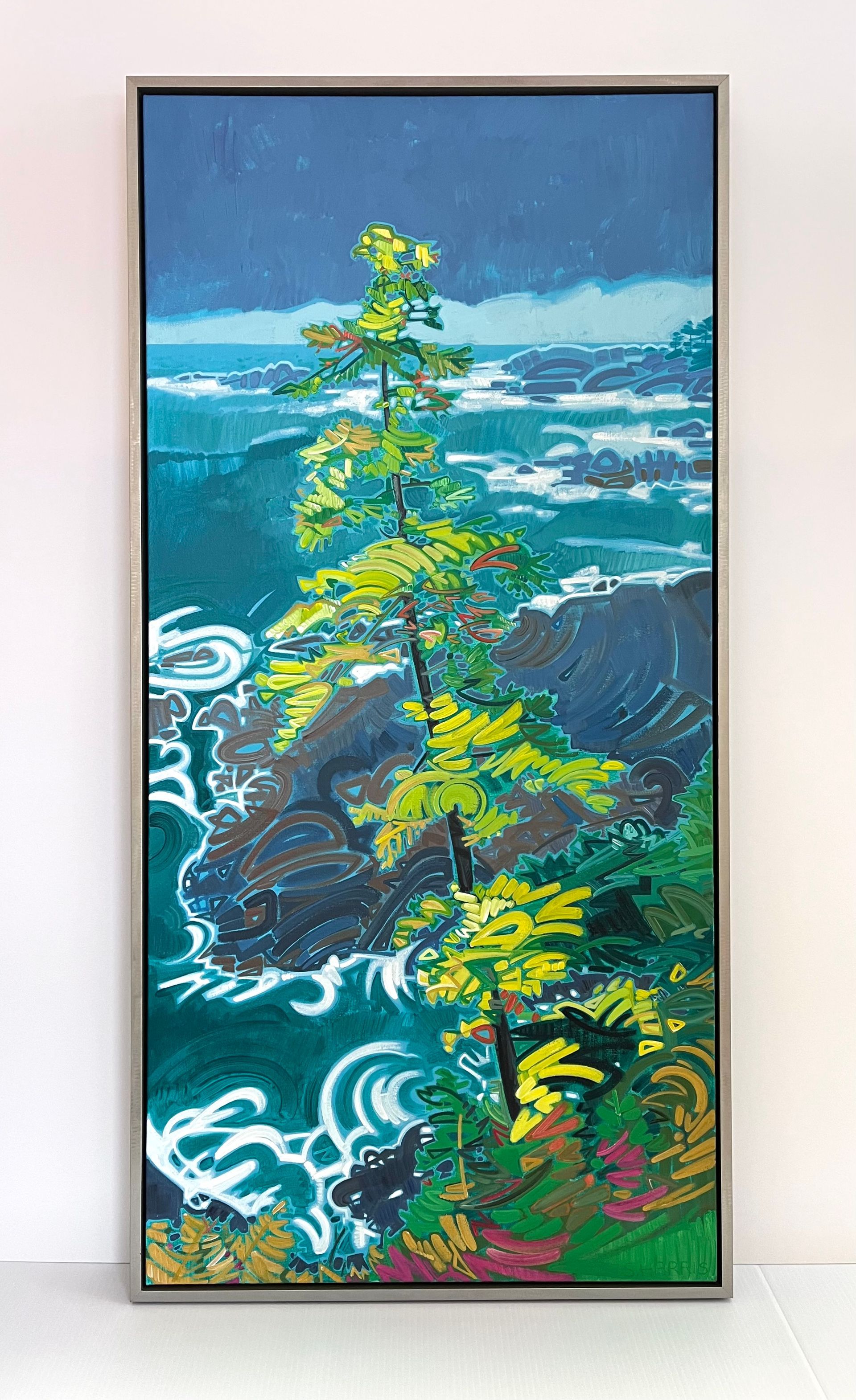 A tall, slender pine tree stands on a dark, rocky cliff overlooking a turbulent, deep blue-green ocean under a dark sky.