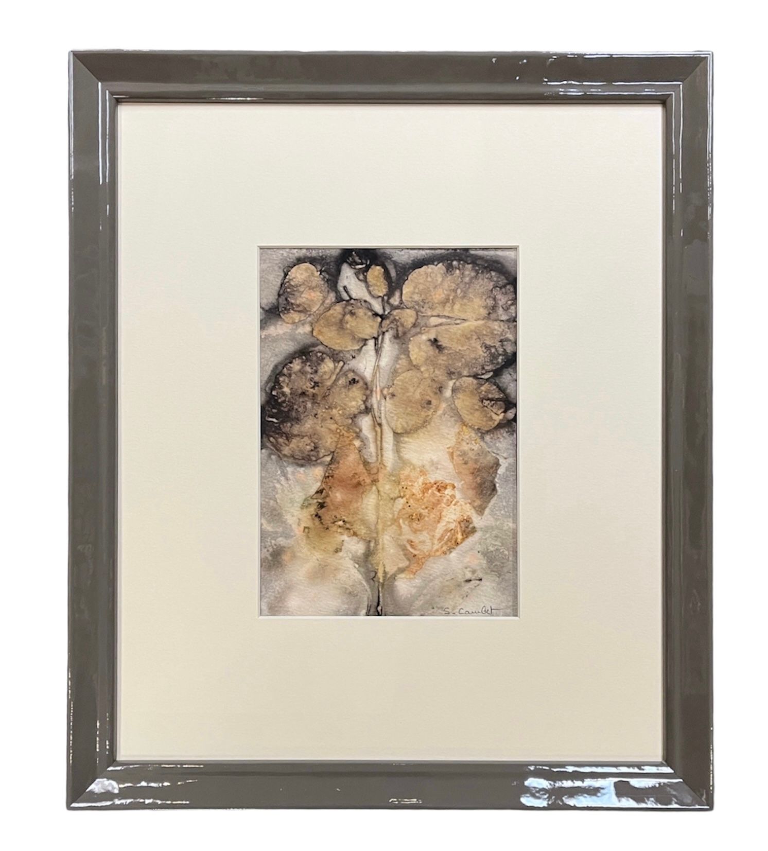 A framed piece of nature-inspired artwork featuring pressed, botanical elements in warm earth tones on a light background.