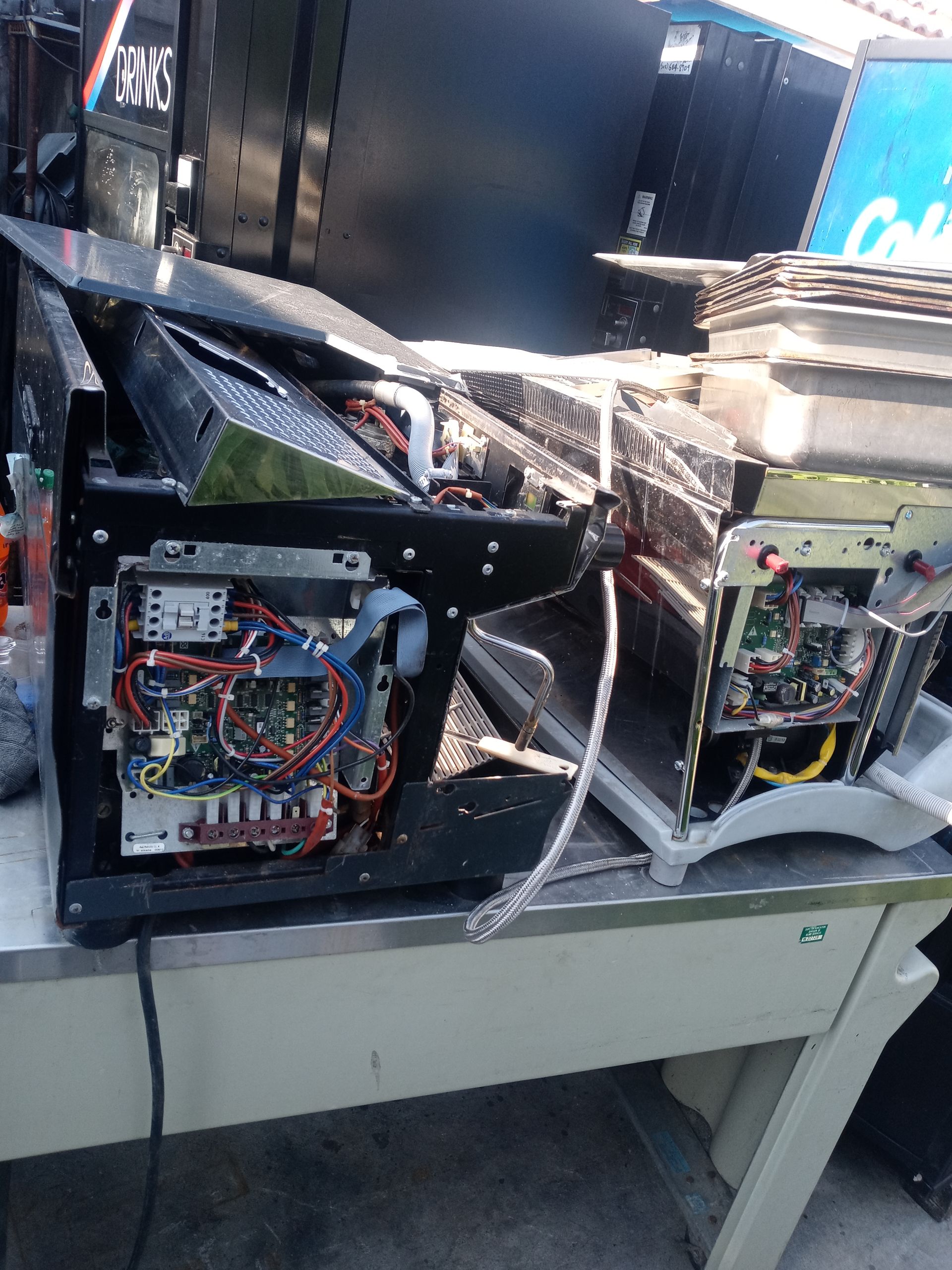 Open electronics workstation with exposed wiring and circuit boards on a metal table