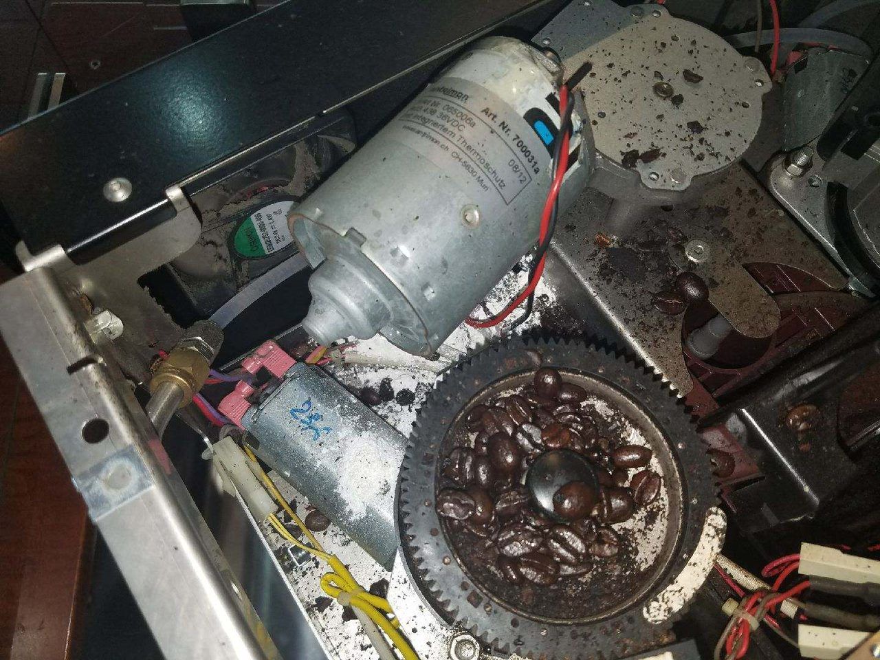 Damaged computer hardware with a burned motor and charred components inside a metal case