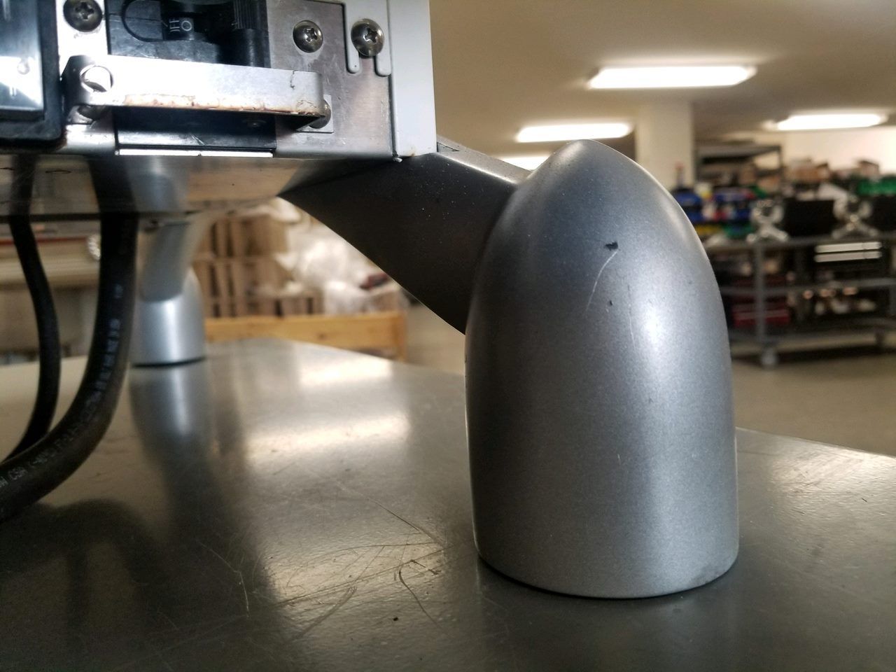 Silver computer mouse on a desk beside office equipment