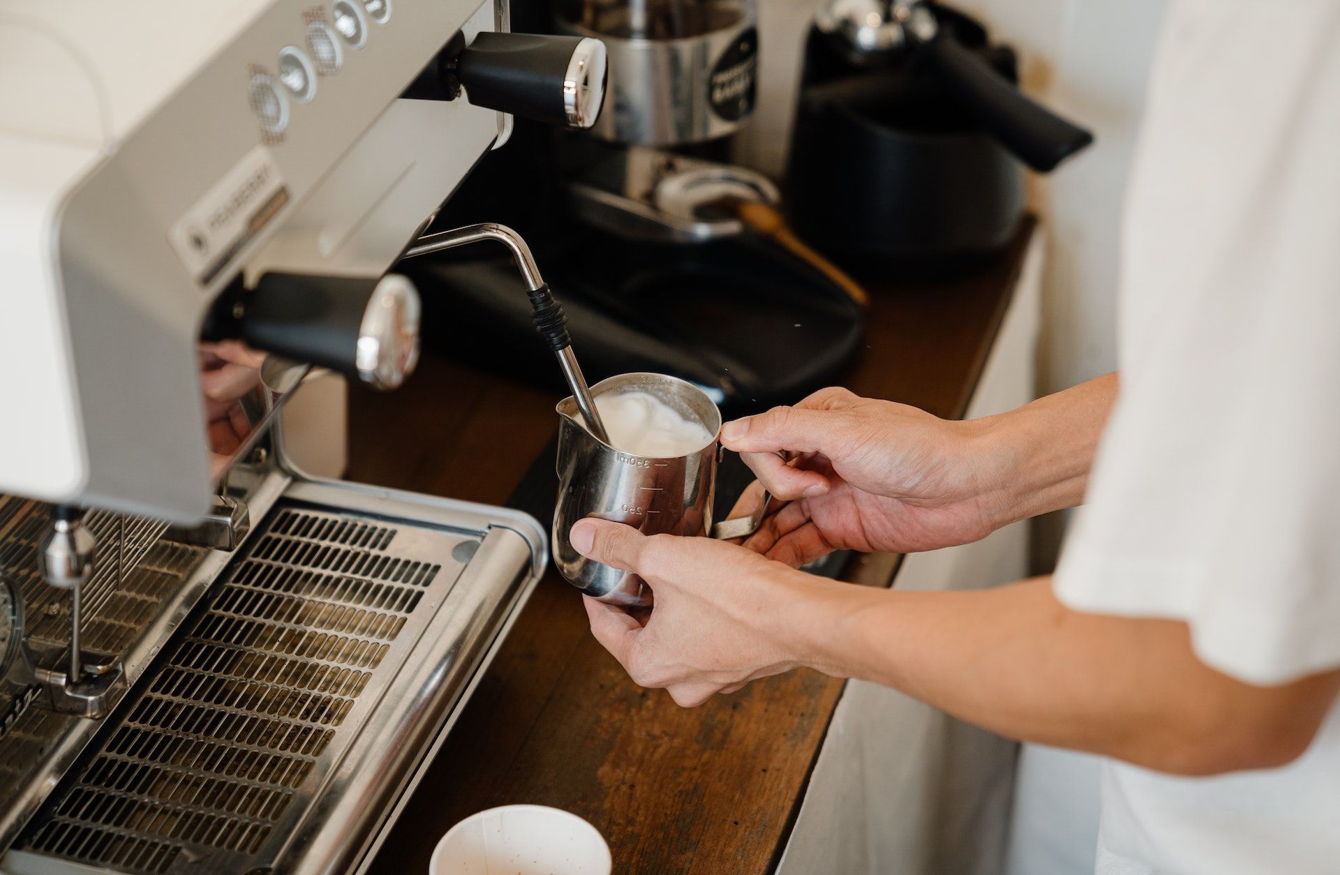 Person Holding Stainless Steel Cup