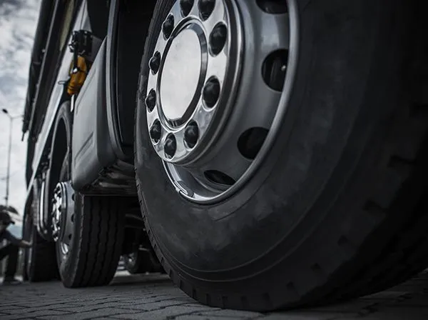 Close-up of a large truck’s wheels and tires on a wet road