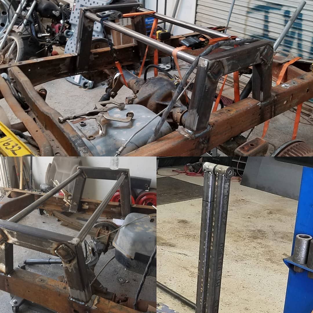 A rusty vehicle frame with a custom metal structure welded on, possibly for a 