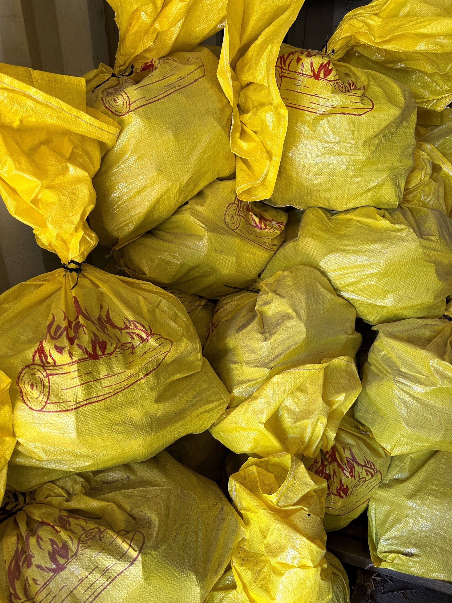 A Pile of Yellow Bags Stacked on Top of Each Other — Dampier Street Landscape Supplies in Taminda, NSW