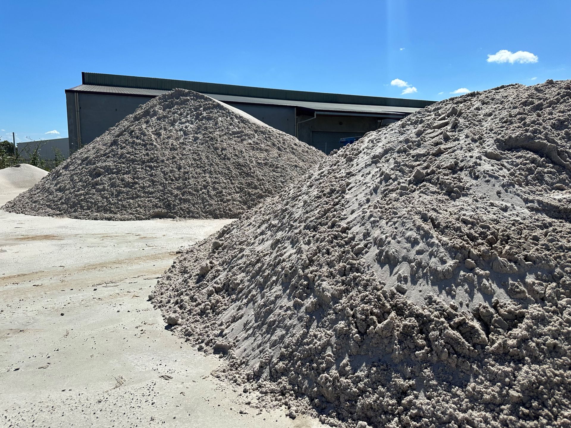 A Pile of Sand is Sitting in Front of a Building — Dampier Street Landscape Supplies in Taminda, NSW