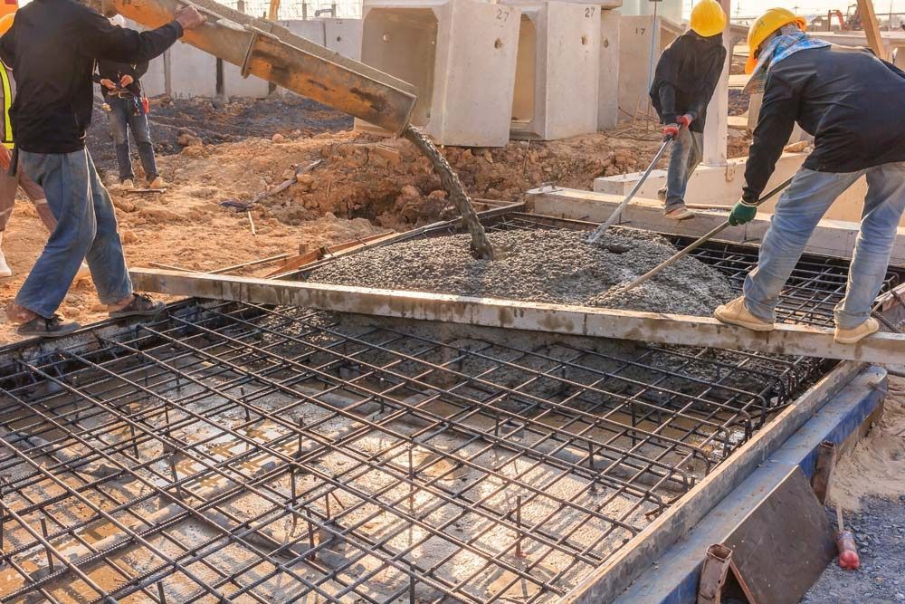 A Group of Construction Workers Are Working on a Concrete Floor — Dampier Street Landscape Supplies in Taminda, NSW