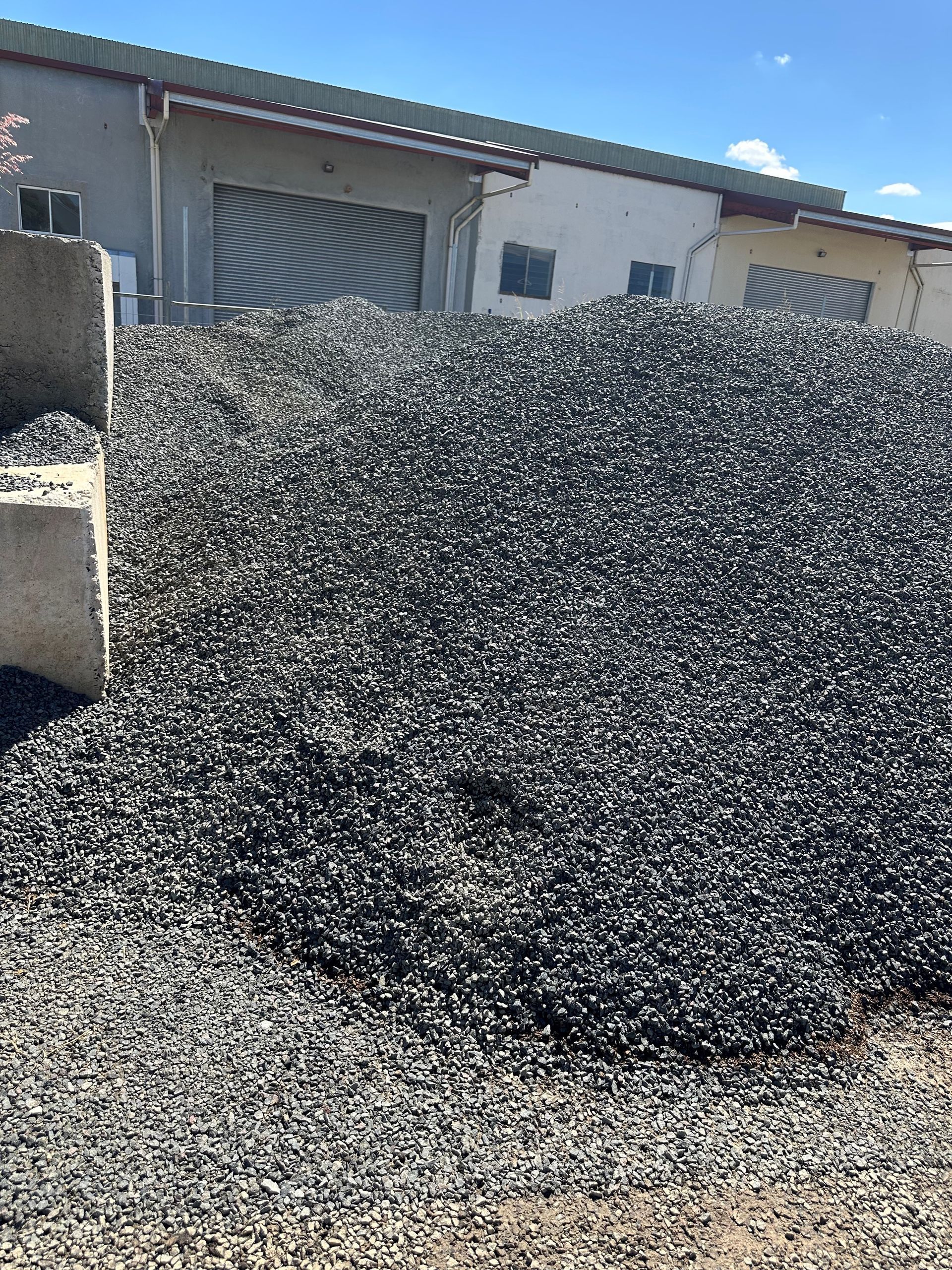 A Pile of Gravel is Sitting in Front of a Building — Dampier Street Landscape Supplies in Taminda, NSW