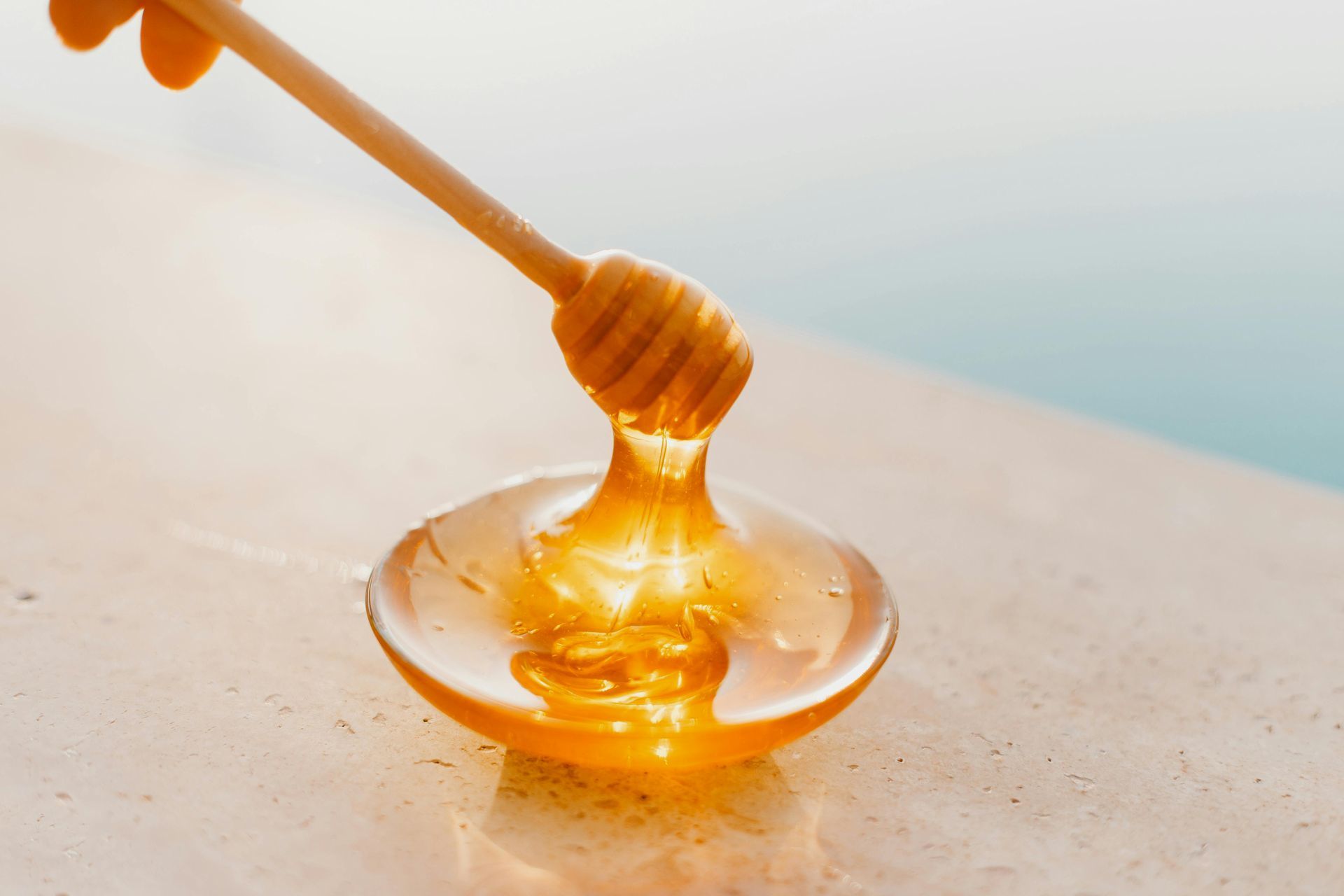 Local Raw Honey in a Bowl with a Honeystick