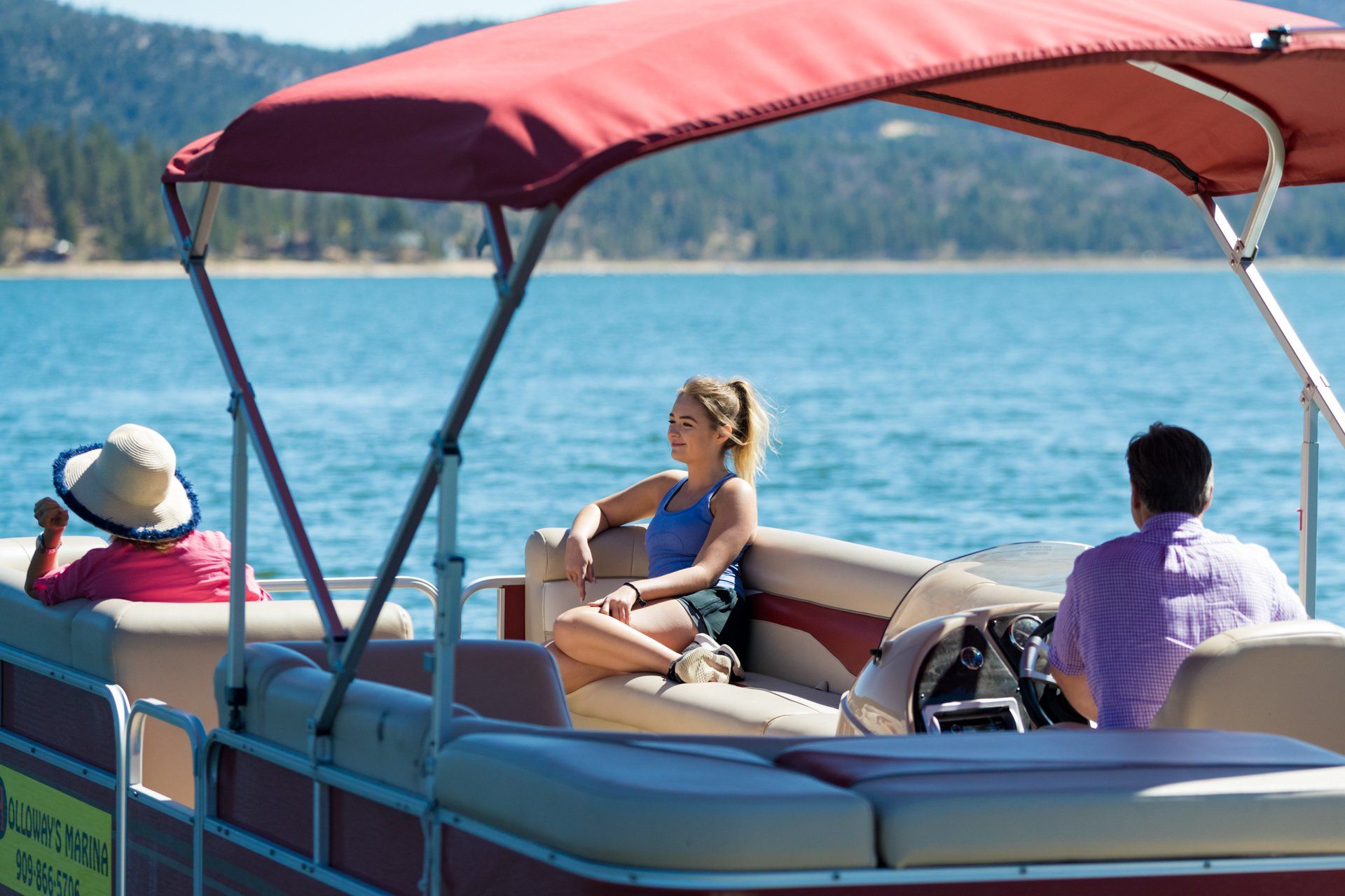 3 people sitting on pontoon boat