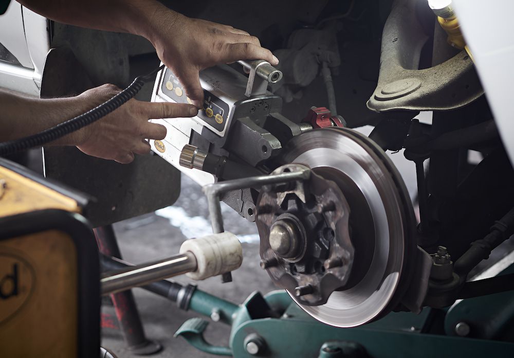 A Man Is Repairing A Brake Disc On A Car β 100% Automotive In South Nowra, NSW