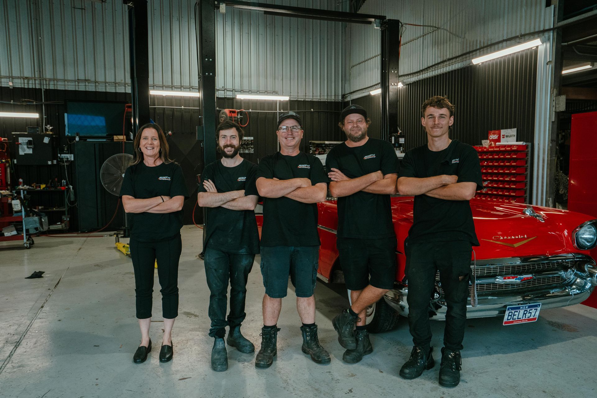 A Man Is Working On A Car In A Garage β 100% Automotive In South Nowra, NSW