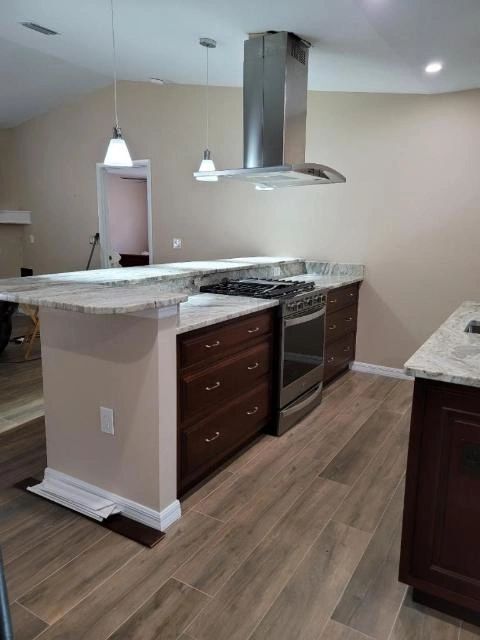 A kitchen with stainless steel appliances and wooden cabinets