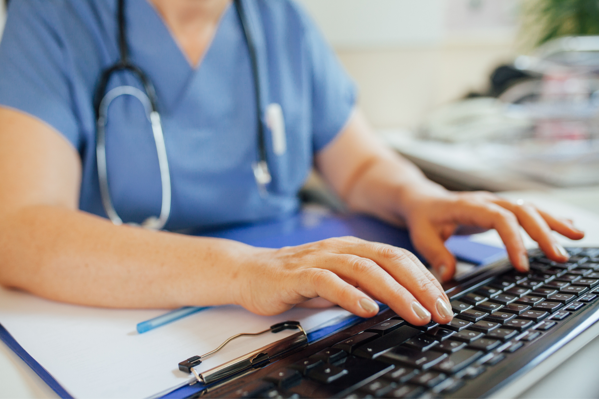 Health professional typing on keyboard 