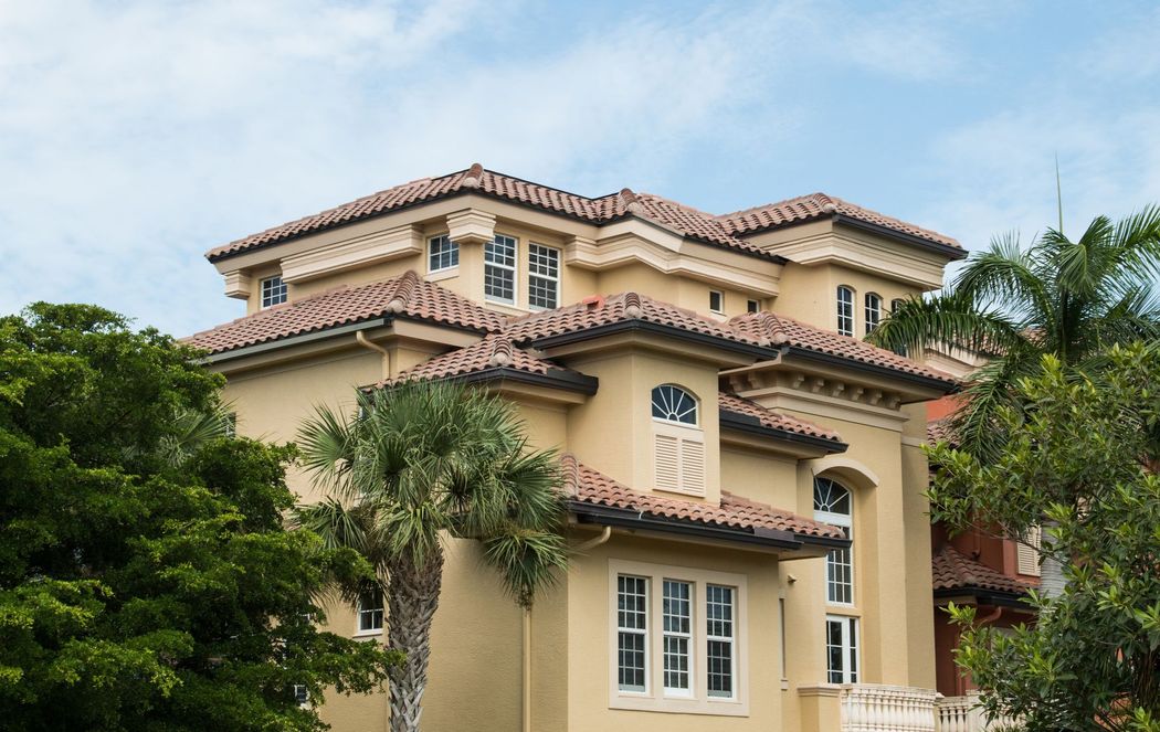 Florida barrel tile roof being soft washed — half clean, half treated