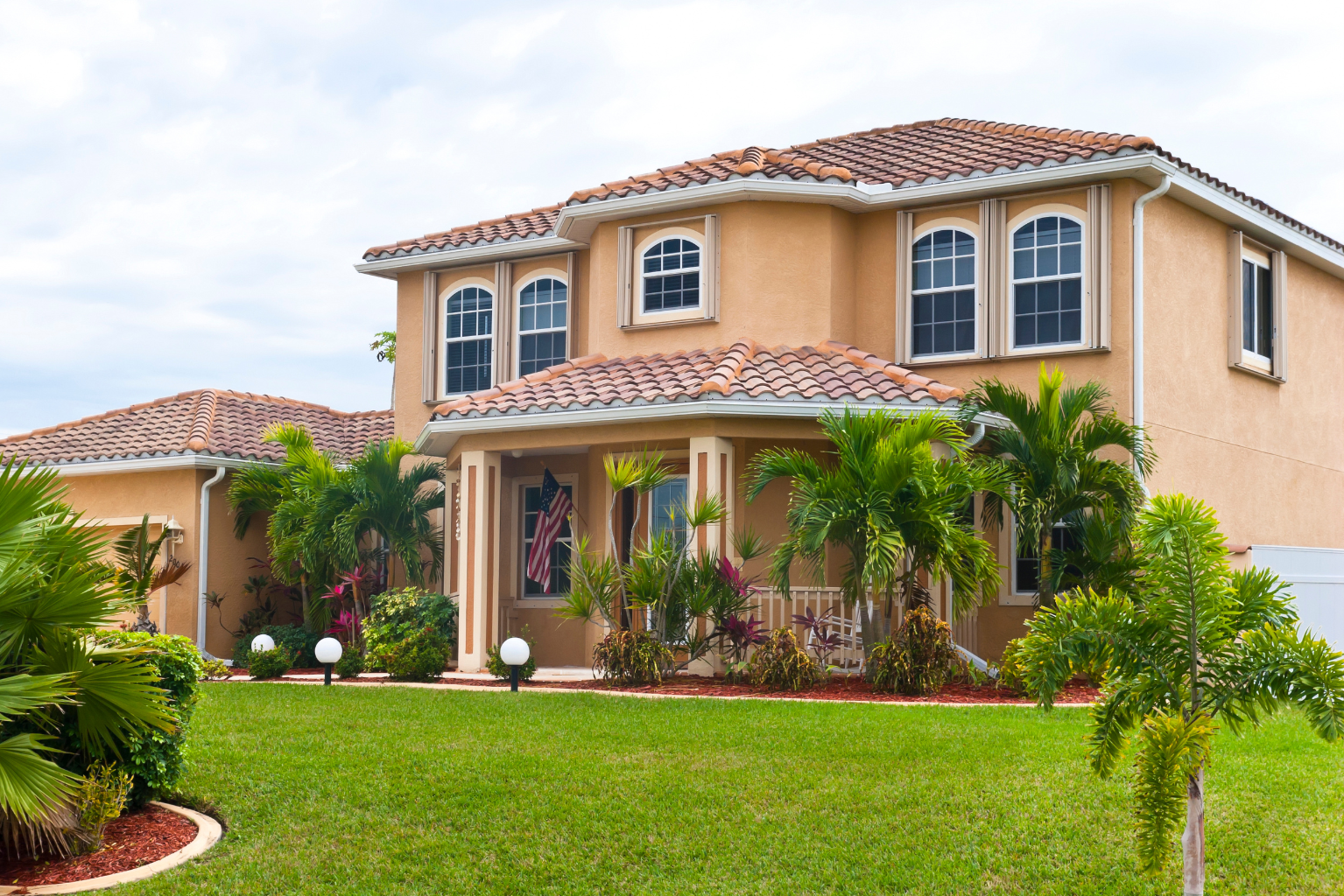 Florida barrel tile roof being soft washed — half clean, half treated
