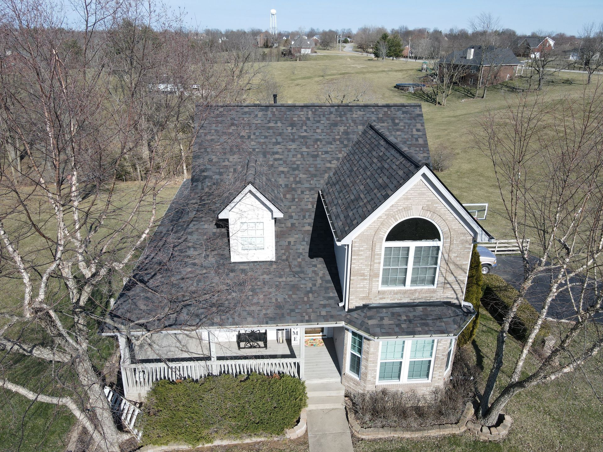 An aerial view of a house with a black roof
