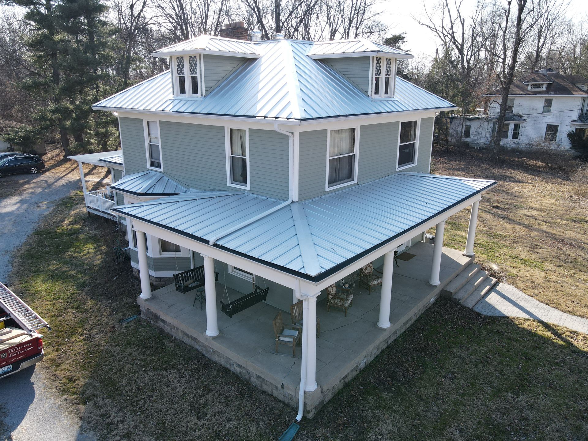 An aerial view of a house with a metal roof
